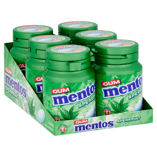 A six-pack display of Mentos Spearmint sugar-free gum in green plastic jars with matching green lids, arranged in a branded cardboard tray on a white background.